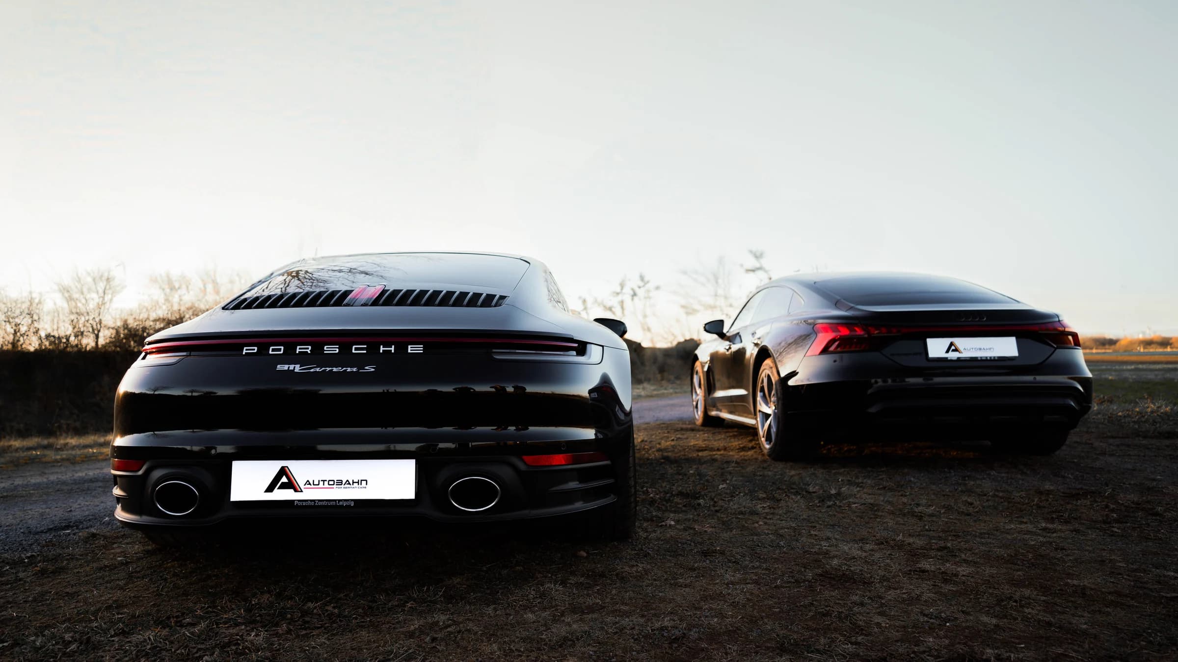 Black Porsche and Audi vehicles with Autobahn display plates